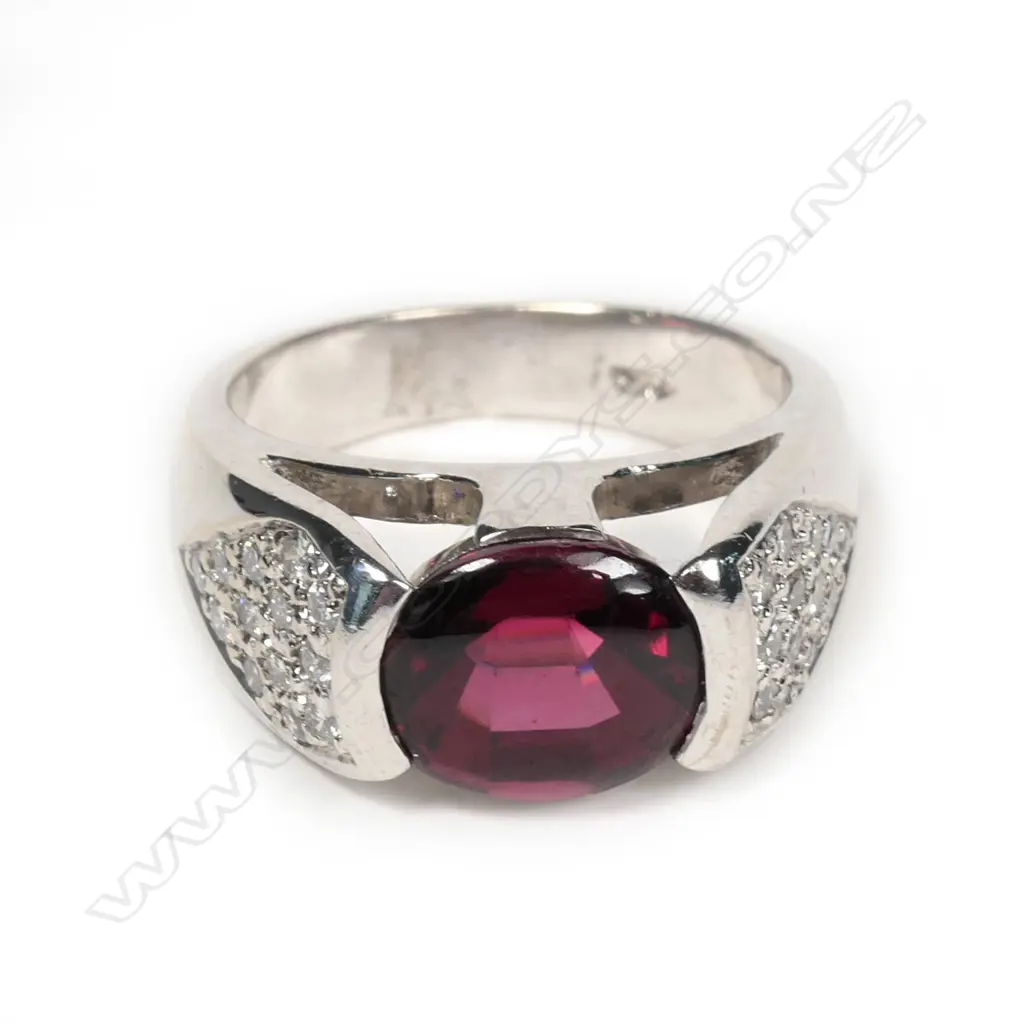 An 18ct white gold garnet and diamond ring Image 1++