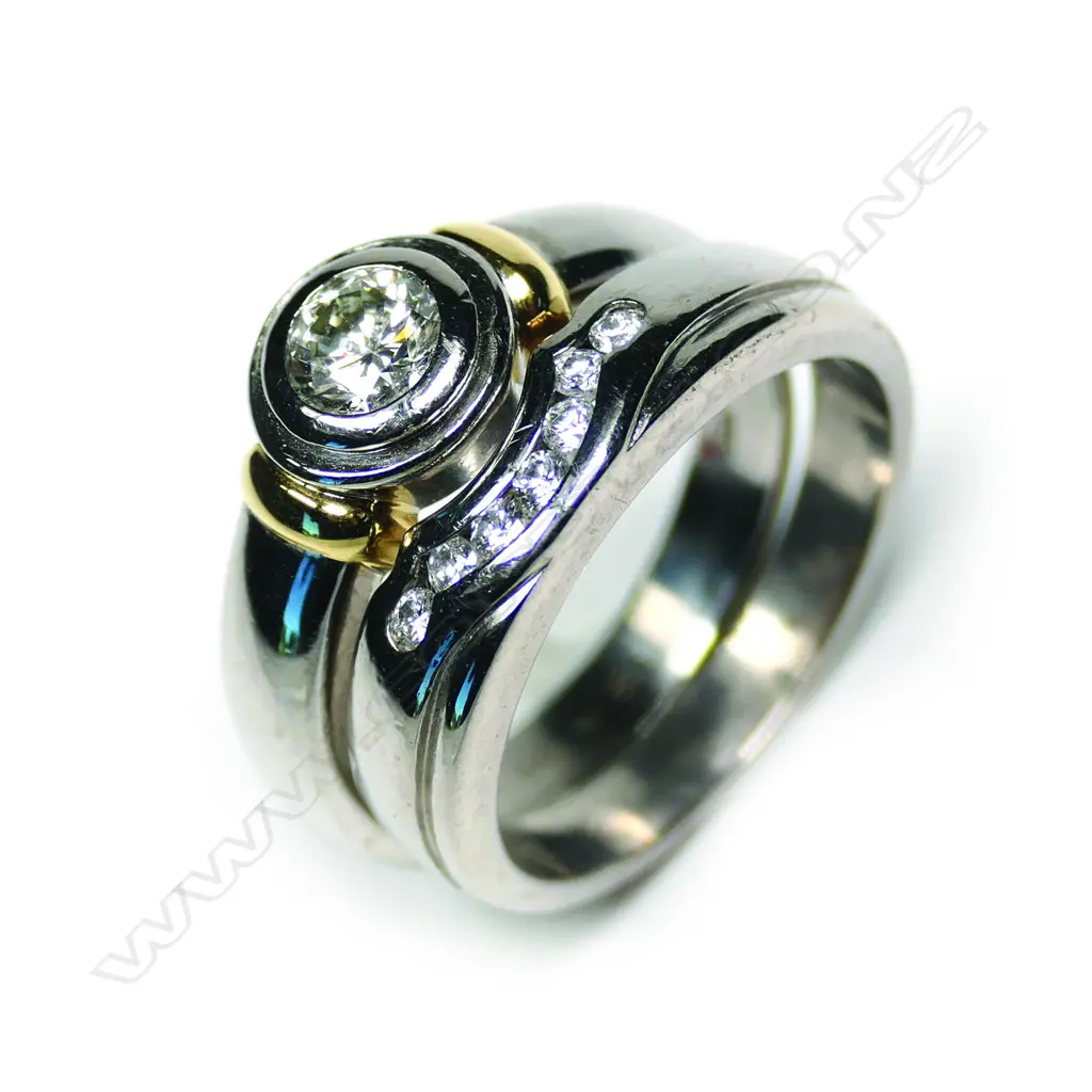 A pair of modern 18ct white gold and diamond solitaire and wedding rings Image 1++