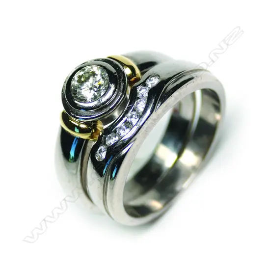 A pair of modern 18ct white gold and diamond solitaire and wedding rings