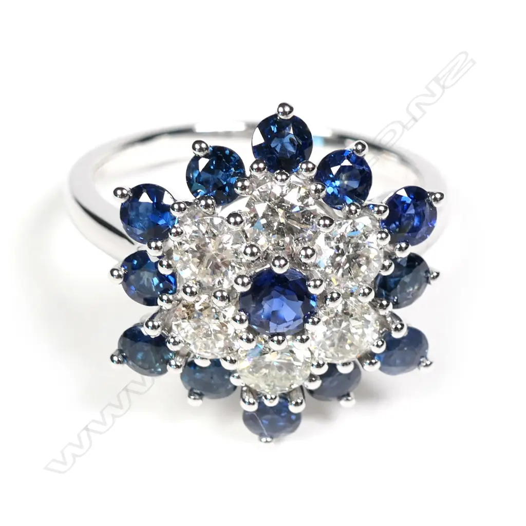 A 14ct white gold sapphire and diamond cluster ring Image 1++