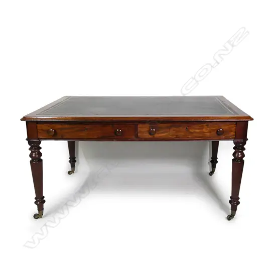 A Victorian oak or mahogany leather top library table