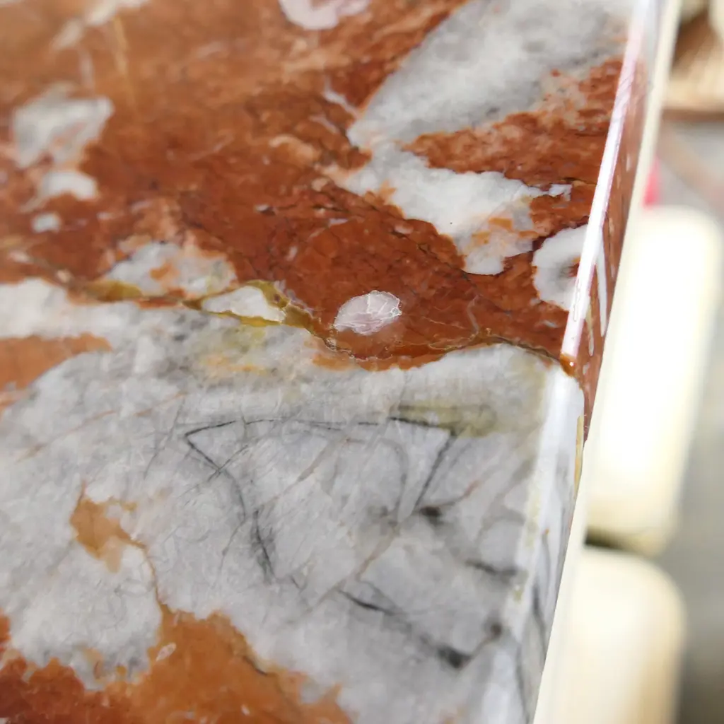 A pair of stylish French plinths, cream painted gesso and parcel gilt with rouge griotte marble tops, each of tapering shape with concealed cabinets surmounted by swollen capitals and raised from cavetto plinths. Marble repaired to one. 610 x 410 x 1350mm. Image 1++