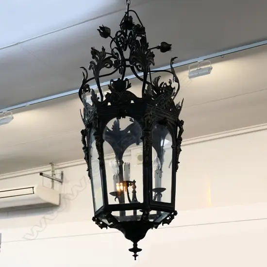 A large wrought iron and glass French style portico light