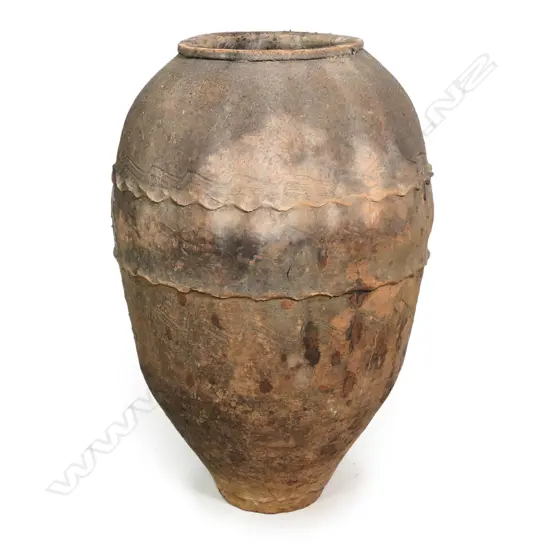 An old European terracotta tall olive oil storage jar