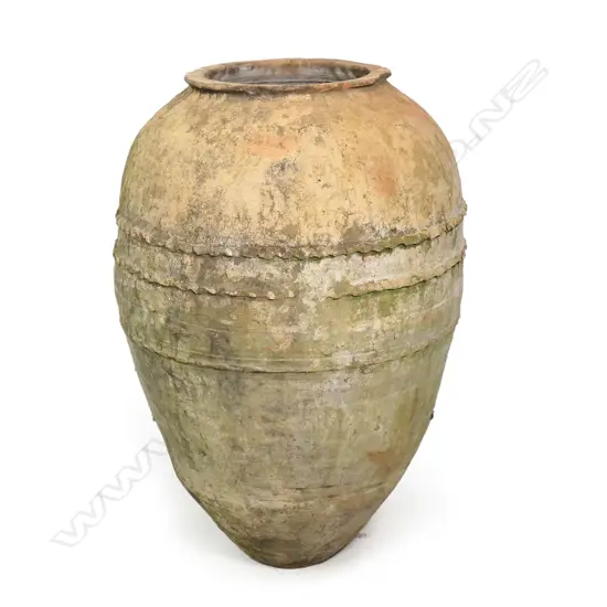 An old European terracotta tall olive oil storage jar