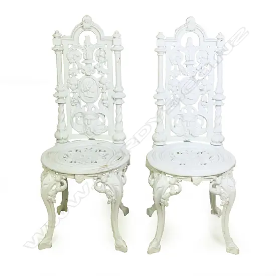 A pair of cast iron high back chairs