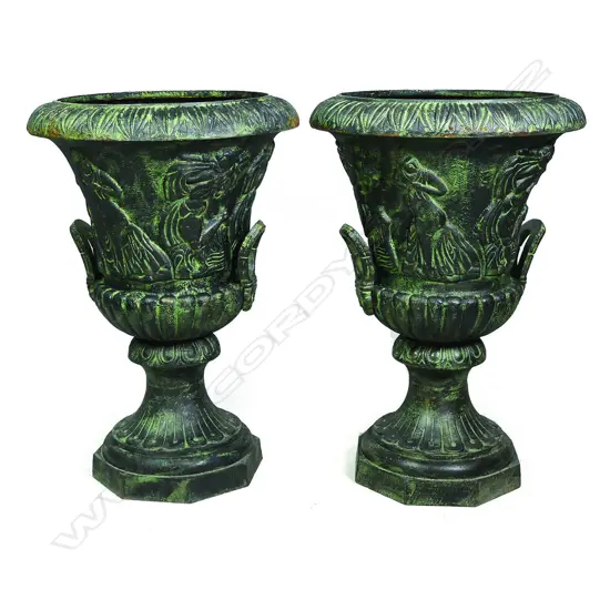 A pair of cast iron garden urns