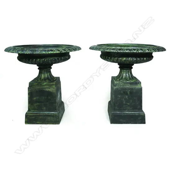 A pair of large and impressive cast iron garden urns