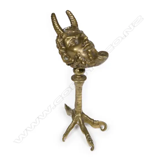 A vintage bronze cigar lighter modelled as the devil's head
