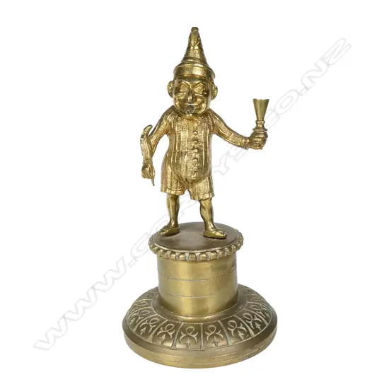A vintage brass Mr. Punch cigar lighter