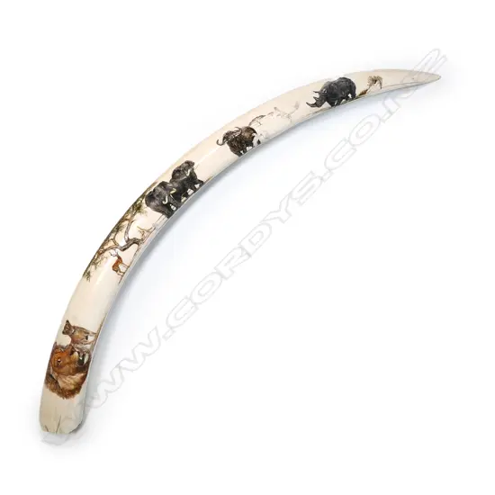 A small elephant tusk with fine engraved decoration of African animals and birds