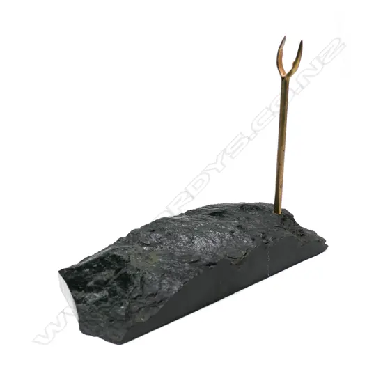 A contemporary dark pounamu mere display stand