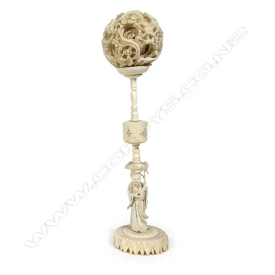 A Chinese carved ivory puzzle ball on stand