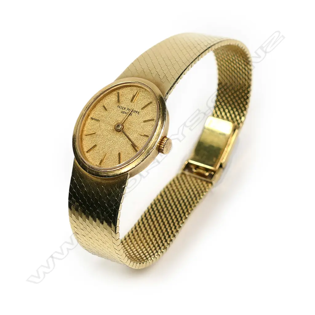 A vintage 18ct gold lady’s Patek Philippe wristwatch, oval case with gilt dial and original 18ct PP integral mesh strap and latch clasp with makers emblem. 41.3gm total. Image 1++