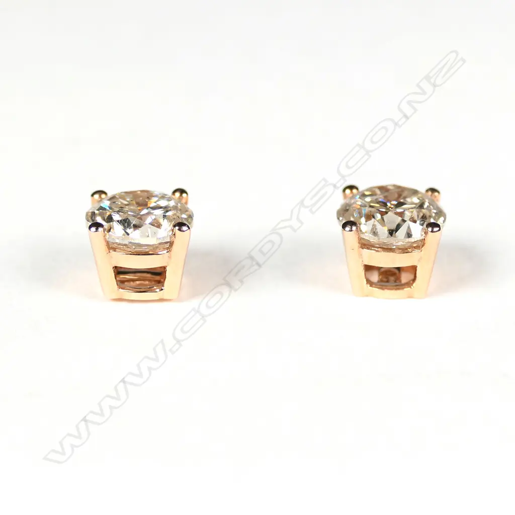A pair of 14ct rose gold diamond stud earrings Image 1++