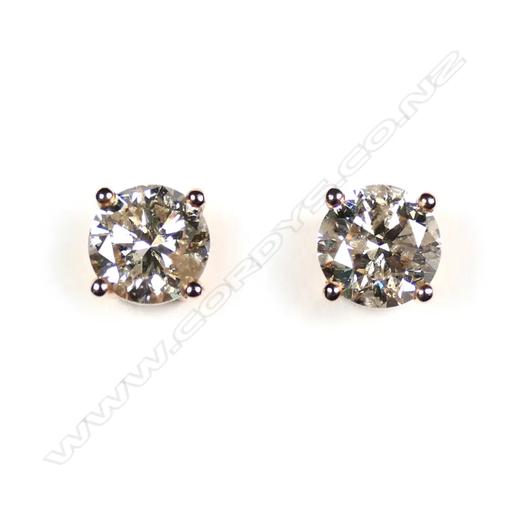 A pair of 14ct rose gold diamond stud earrings Image 1++