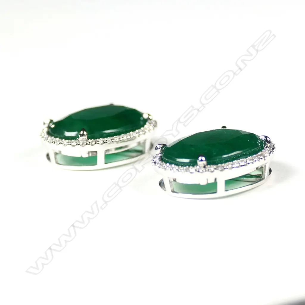 A pair of 14ct white gold emerald and diamond halo stud earrings Image 1++