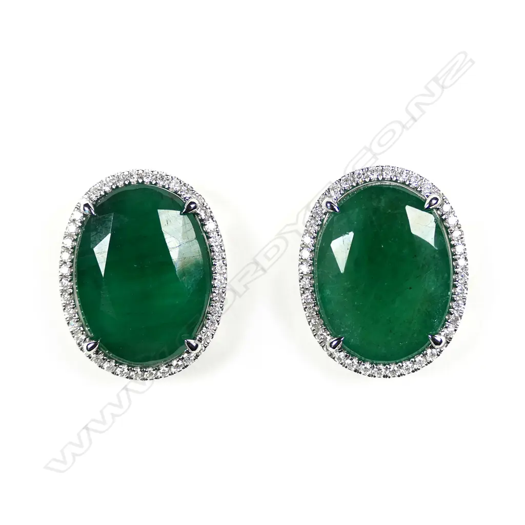 A pair of 14ct white gold emerald and diamond halo stud earrings Image 1++