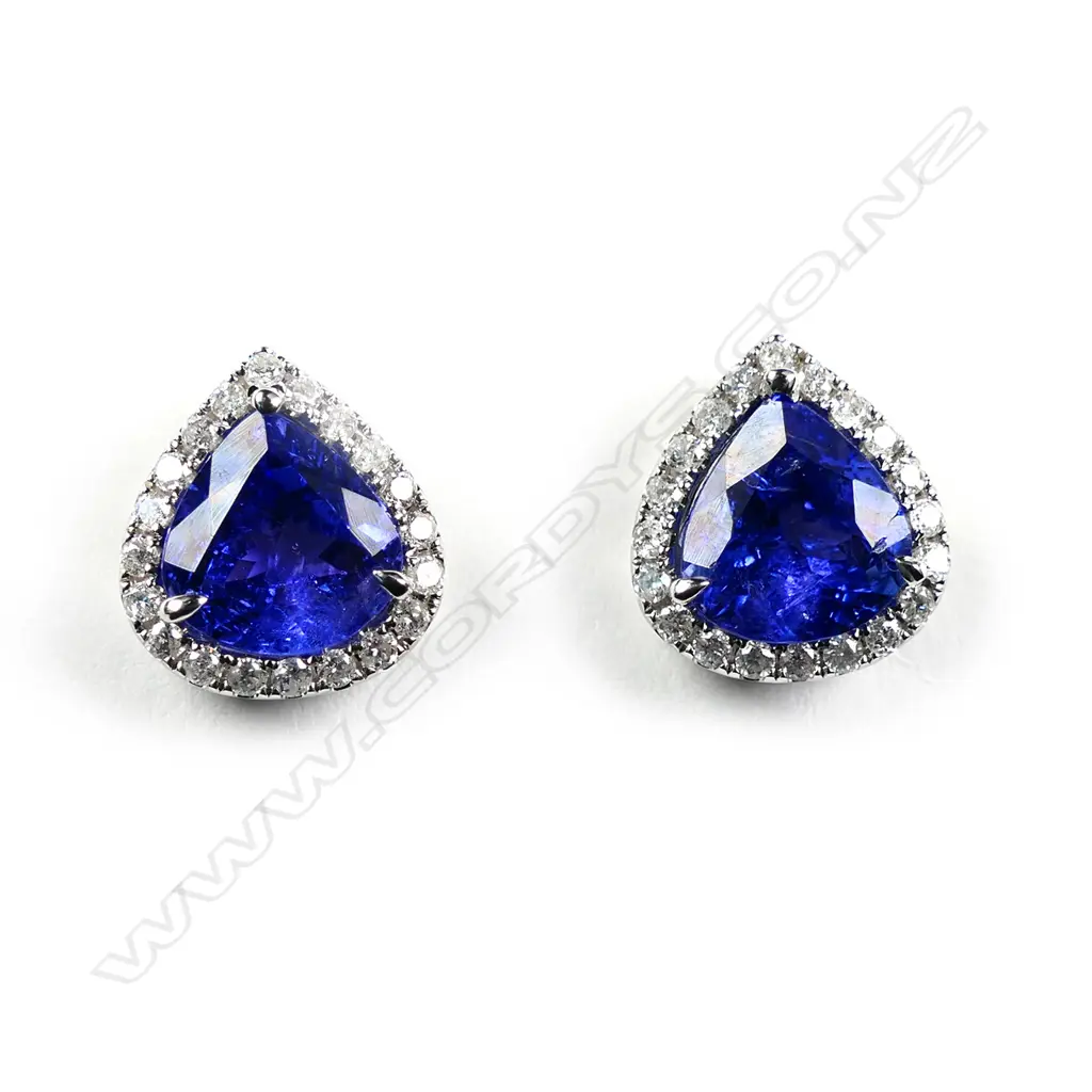A pair of 14ct white gold tanzanite and diamond halo stud earrings Image 1++