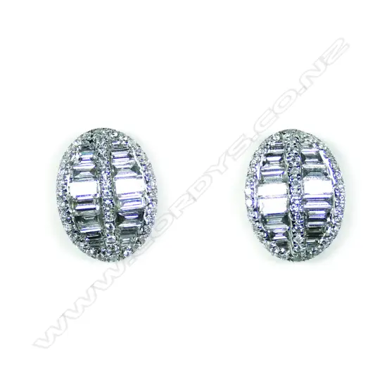 A pair of 18ct white gold and diamond oval shield form cluster earrings