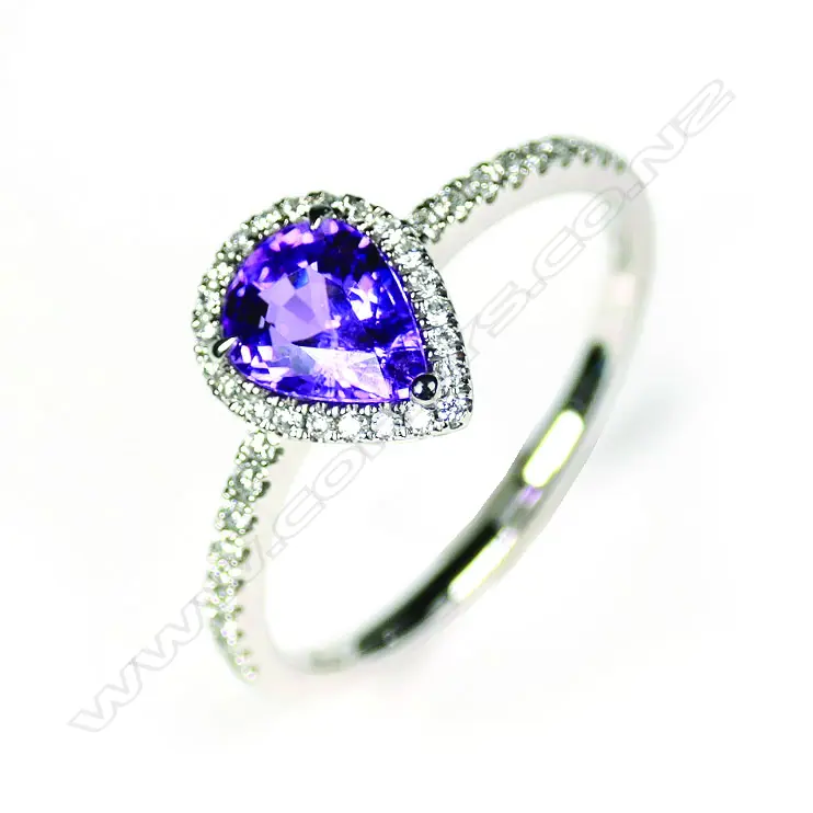 A 14ct white gold sapphire and diamond halo ring Image 1++
