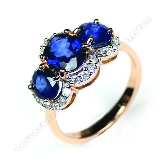 A 14ct rose gold sapphire and Diamond trilogy halo ring