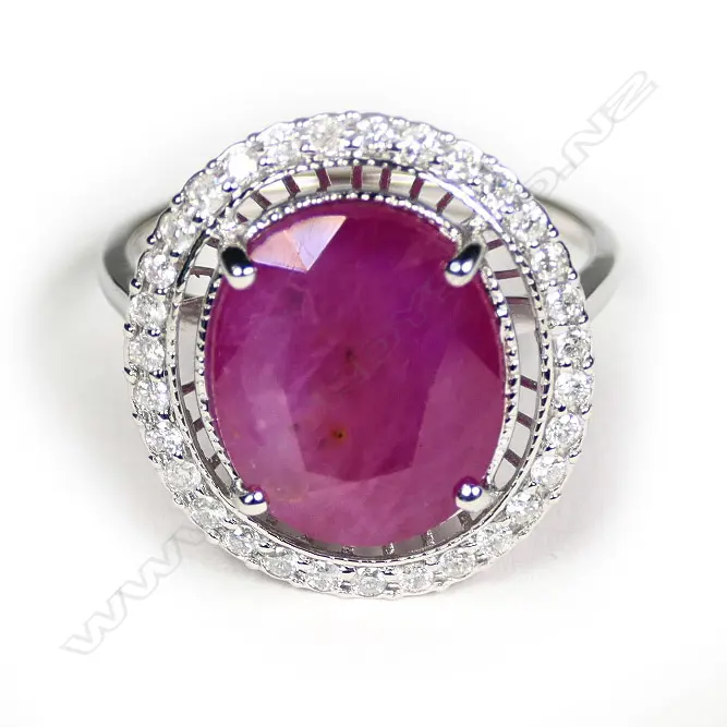A 14ct white gold ruby and diamond halo ring Image 1++