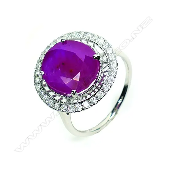 A 14ct white gold ruby and diamond halo ring