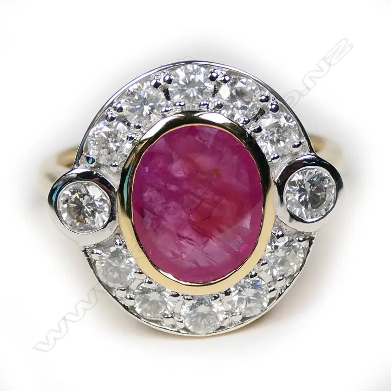 A 14ct yellow gold ruby and diamond halo ring Image 1++