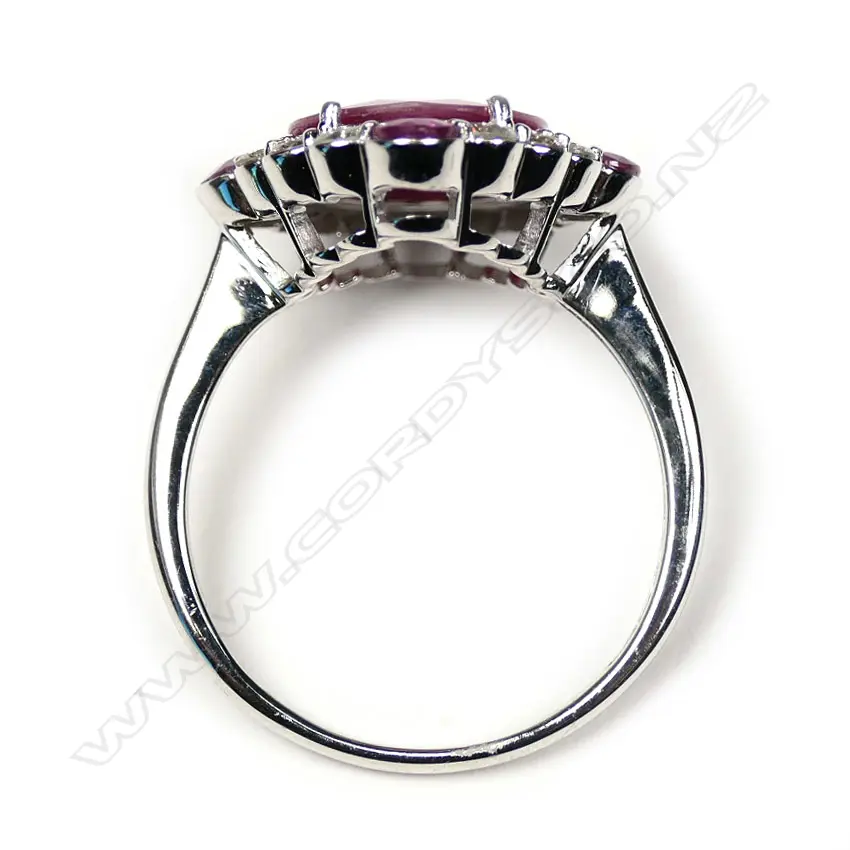 A 14ct white gold ruby and diamond halo ring Image 1++