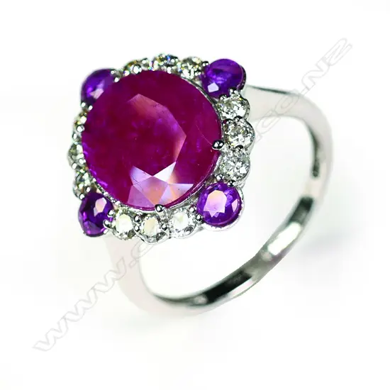 A 14ct white gold ruby and diamond halo ring