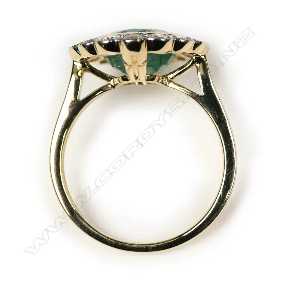 A 14ct gold Zambian emerald and diamond halo ring Image 1++