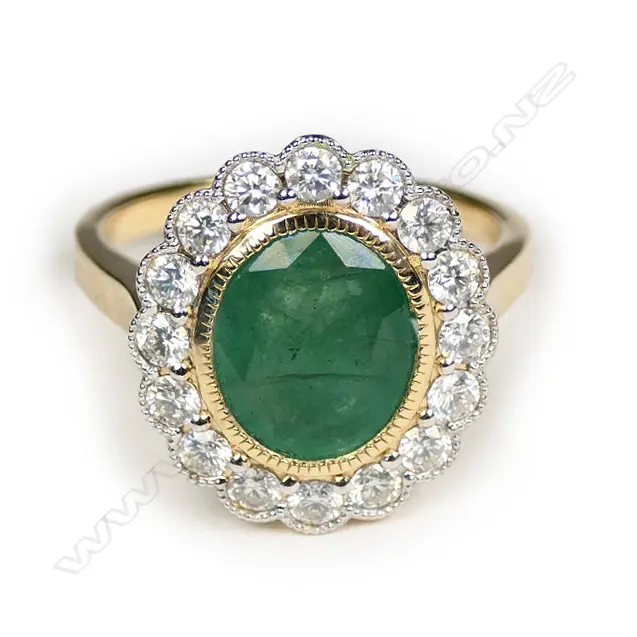 A 14ct gold Zambian emerald and diamond halo ring Image 1++