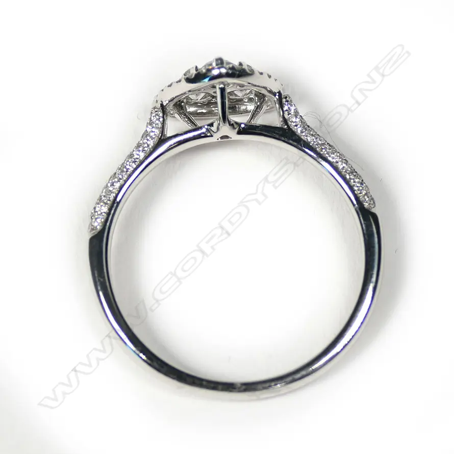 An 18ct white gold diamond cluster ring of triangular form Image 1++