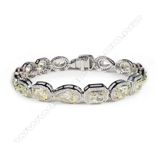 A 14ct white gold fancy yellow diamond halo bracelet