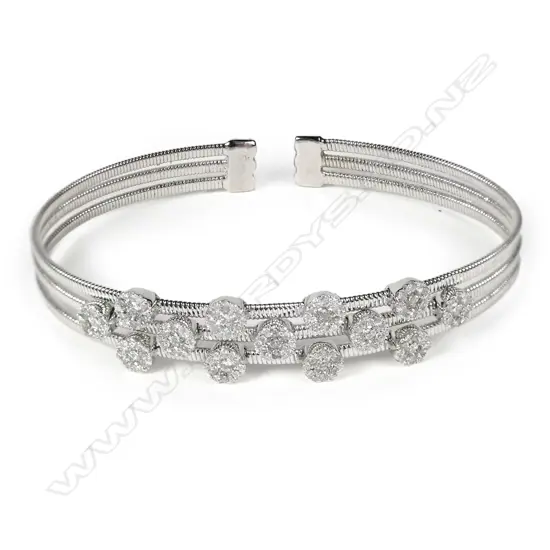 An 18ct white gold and diamond set bangle