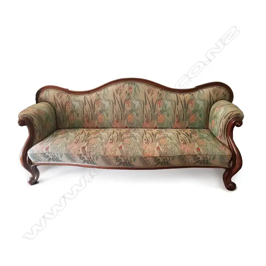 A Victorian mahogany camel-back three/four-seater sofa