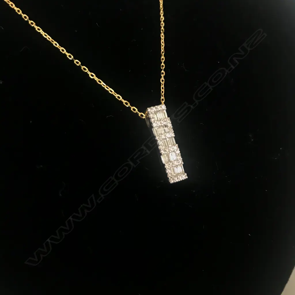 An 18ct yellow gold and diamond pendant on silver chain Image 1++