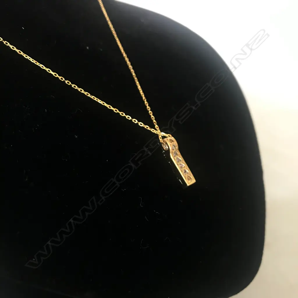 An 18ct yellow gold and diamond pendant on silver chain Image 1++