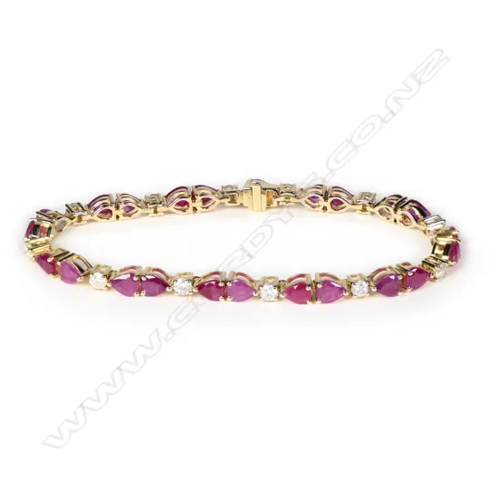 A 14ct gold ruby and diamond line bracelet