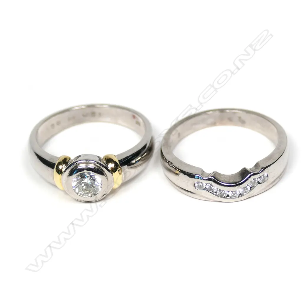 A pair of modern 18ct white gold and diamond solitaire and wedding rings Image 1++