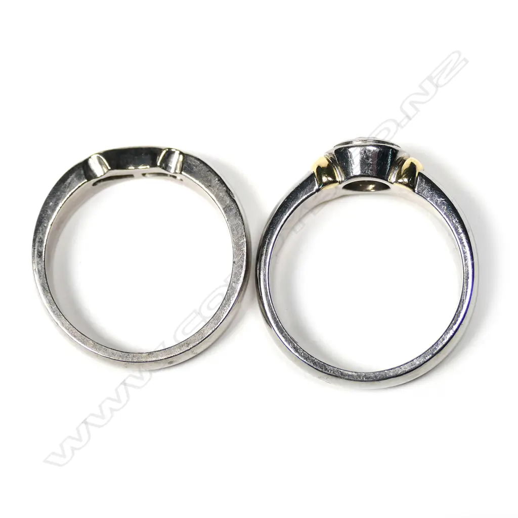 A pair of modern 18ct white gold and diamond solitaire and wedding rings Image 1++