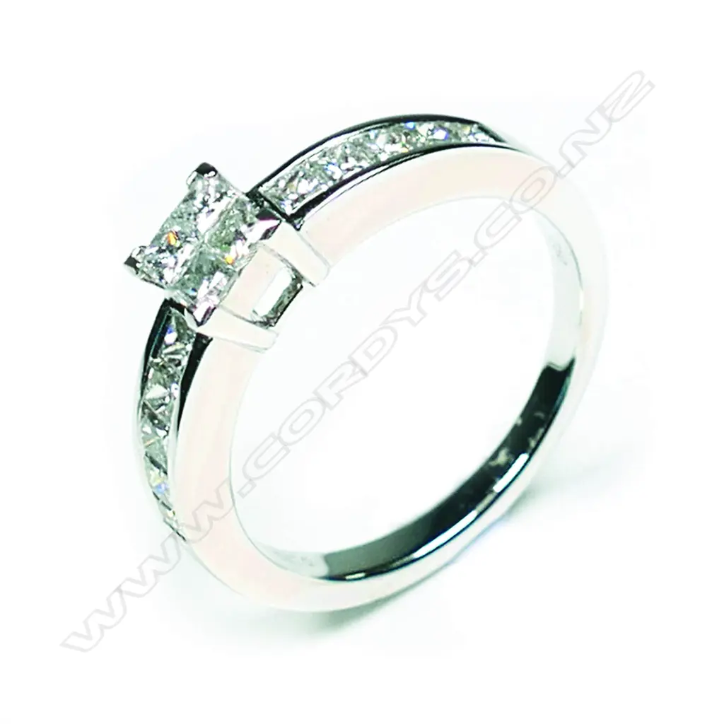 An 18ct white gold and diamond ring the raised square top with four princess cut diamonds Image 1++