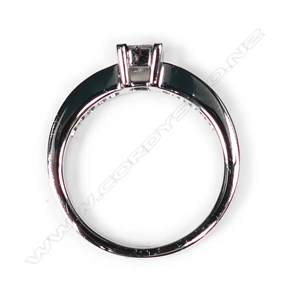 An 18ct white gold and diamond ring the raised square top with four princess cut diamonds Image 1++