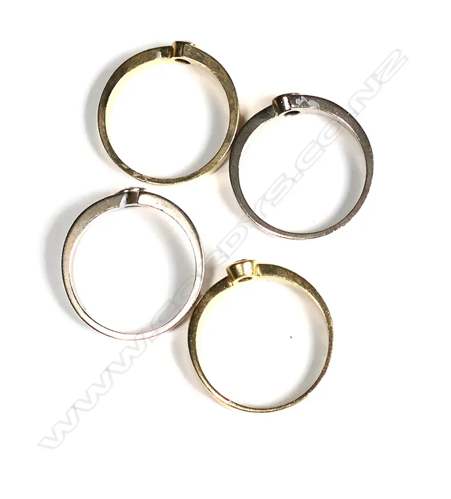 An 18ct gold and diamond four ring stacking set Image 1++