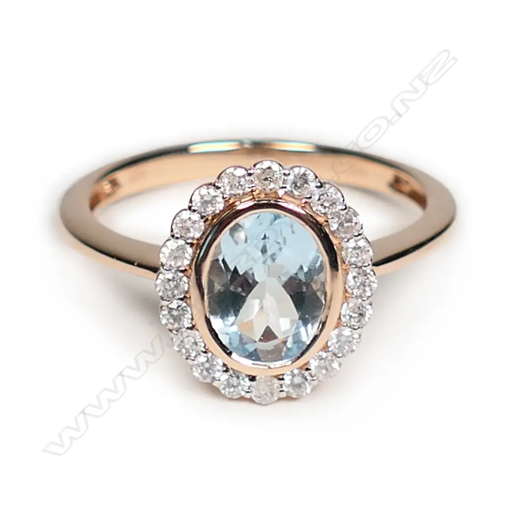 A 14ct rose gold aquamarine and diamond halo ring Image 1++