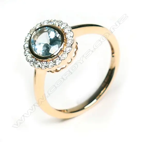 A 14ct rose gold aquamarine and diamond halo ring