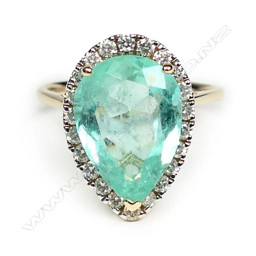 A 14ct gold Colombian emerald and diamond halo ring Image 1++