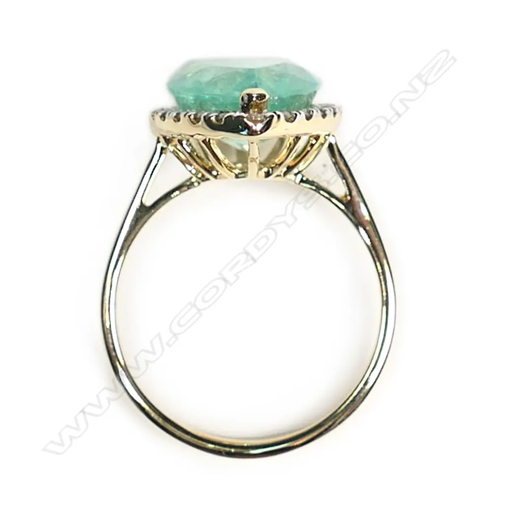 A 14ct gold Colombian emerald and diamond halo ring Image 1++