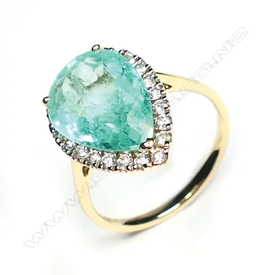A 14ct gold Colombian emerald and diamond halo ring